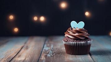 Chocolate cupcake with blue heart on top and lights on wooden background. AI Generated. photo