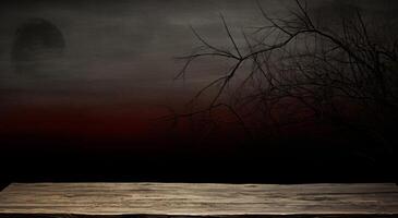 Wooden table in front of a dark background with a tree silhouette. . photo