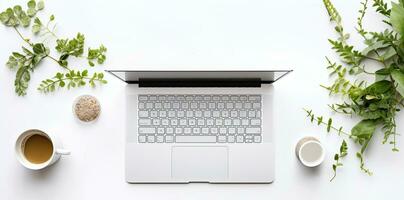Laptop with cup of coffee and green leaves on white background, top view. AI Generated. photo