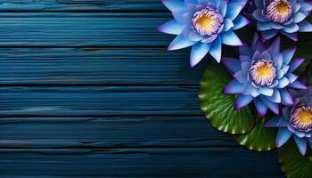 Lotus flower on blue wooden background. Top view with copy space. AI Generated. photo