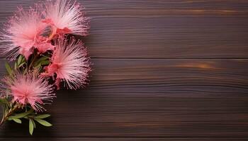 Pink flowers on brown wooden background. Top view with copy space. AI Generated. photo