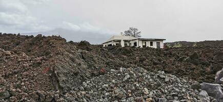 Building destroyed by the volcanic lava flow from the Cumbre Vieja volcano, on the island of La Palma photo