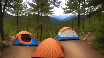 camping within the mountains, tents within the woodland. photo