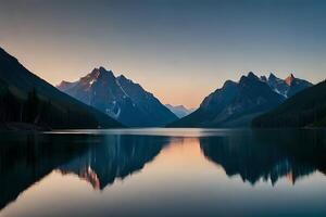 A calm lake reflecting the brilliant mountain crests that cement it. photo