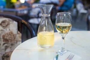 White wine in a liter bottle on a table in a cafe photo