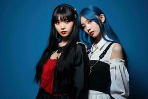 Portrait of two beautiful asian women in Fashion outfits on blue background AI Generated photo