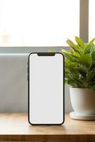 Mockup smartphone with blank screen on table with green plant AI generated photo