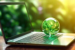Green globe on a laptop keyboard with green bokeh background. photo