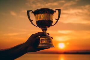 Closeup of a trophy in the hands of a man at sunset photo