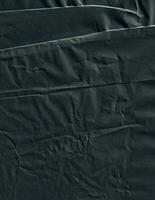 Creased black paper texture background. Crumpled and wrinkled grunge backdrop. photo