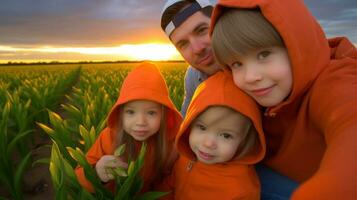 A father with two children wearing orange hoodies taking a selfie. Generative AI photo
