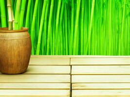 Wooden table on bamboo plant background ai generated photo