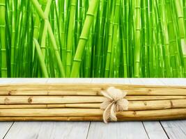 Wooden table on bamboo plant background ai generated photo