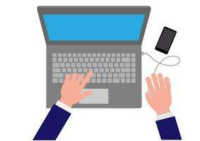 A business man with his hands on the laptop with a smart phone next to it vector
