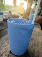 blue ice cube with water photo