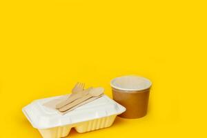 lunchbox with disposable cutlery and paper soup container with copy space photo