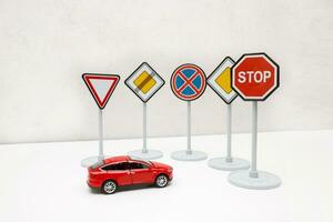 road signs block the path of a red toy car photo