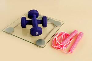 floor scales with dumbbells and jump rope, weight loss photo