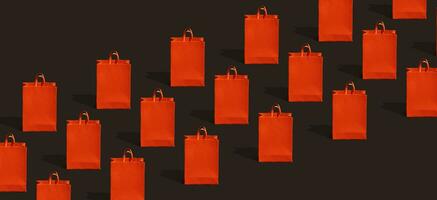 Black friday sale, shopping concept. Red paper shopping bag pattern on black background. photo