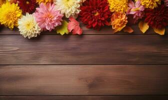 Ai generated Autumn flowers frame on wooden background. Seasonal yellow and red flowers. Autumn background. Space for text. photo