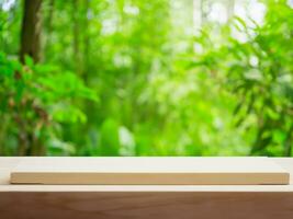 empty wooden tabletop podium in garden open forest, blurred green plants background with space. organic product presents natural placement pedestal display, spring and summer concept photo