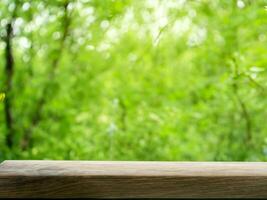 empty wooden tabletop podium in garden open forest, blurred green plants background with space. organic product presents natural placement pedestal display, spring and summer concept photo