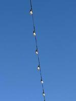 string lights with blue sky as background photo