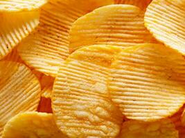 close up of potato chips on a wooden table photo