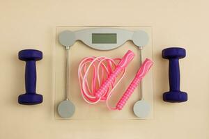 floor scales with dumbbells and jump rope, weight loss photo