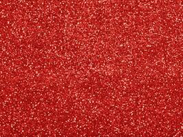 Red christmas glitter background with stars. Festive glowing blurred texture. photo