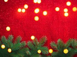 Christmas background with xmas tree and sparkle bokeh lights on red canvas background photo