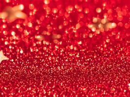 Red christmas glitter background with stars. Festive glowing blurred texture. photo