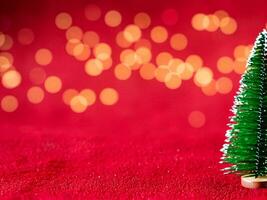 Christmas background with xmas tree and sparkle bokeh lights on red canvas background photo