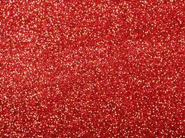 Red christmas glitter background with stars. Festive glowing blurred texture. photo
