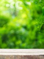 empty wooden tabletop podium in garden open forest, blurred green plants background with space. organic product presents natural placement pedestal display, spring and summer concept photo