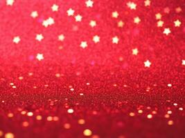 Red christmas glitter background with stars. Festive glowing blurred texture. photo