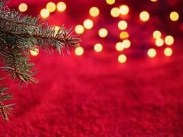 Christmas background with xmas tree and sparkle bokeh lights on red canvas background photo