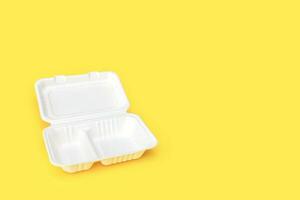 empty open container for food, lunchbox, recycled on yellow background with copy space photo