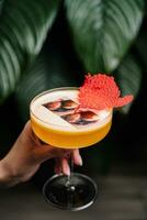 Glass of tasty mango margarita on dark background photo