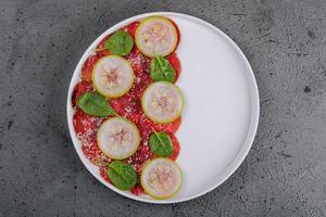 Italian beef carpaccio with sliced zucchini photo