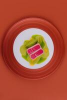 Tuna sashimi and pea puree on plate photo