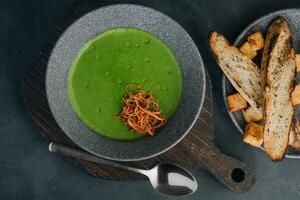 Fresh broccoli cream soup in bowl photo