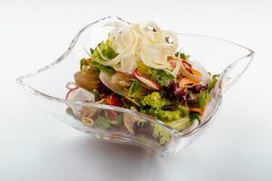 Radish salad in glass bowl isolated on white photo