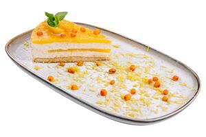 Cheesecake with orange chips on plate photo