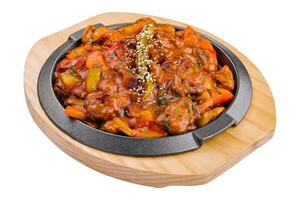 pan with vegetable stew on wooden board photo