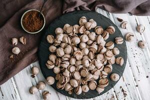 Chocolate meringues scattered on the table photo