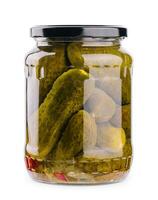 A glass jar of tasties canned cucumbers on white background photo