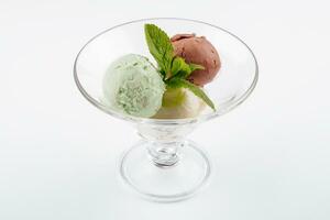 Three balls of ice cream in a transparent glass photo