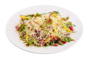 Fresh healthy salad with cheese and pomegranate photo