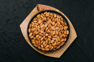 Organic roasted salty peanuts in a pan photo